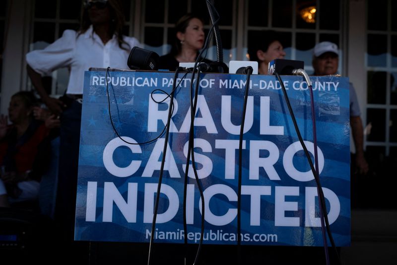 A sign is pictured as Cubans gather outside Versailles Cafe after the U.S. Department of Justice announced criminal charges against former Cuban President Raul Castro, in Miami, Florida, U.S., May 20, 2026. REUTERS/Marco Bello