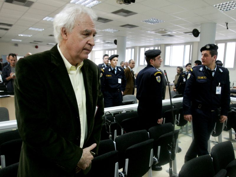 FILE PHOTO: Alexandros Giotopoulos (L), leader of Greece's notorious November 17 urban guerrillas, stands inside a court room in Korydallos prison, a few kilometres west of Athens December 2, 2005. The 15 members of the group returned to court on Friday to appeal multiple life sentences handed down two years ago for a 27-year killing spree with Giotopoulos demanding his full acquittal. REUTERS/Yiorgos Karahalis/File Photo