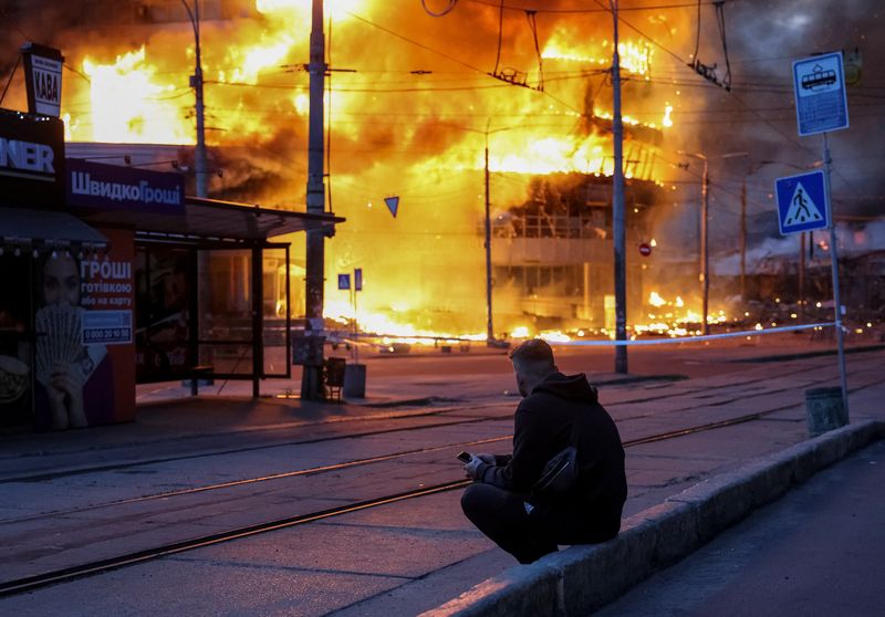 A resident sits at a site of a Russian missile and drone strike, amid Russia's attack on Ukraine, in Kyiv, Ukraine May 24, 2026. REUTERS/Stringer