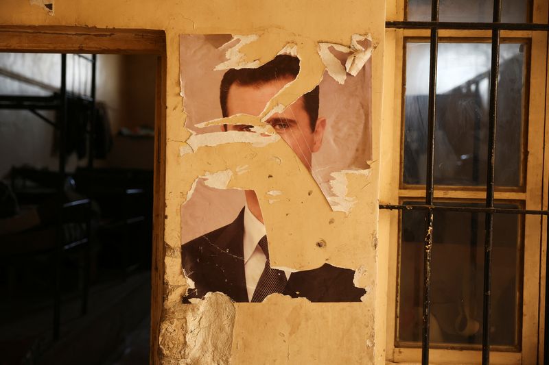 A damaged portrait of former Syrian President Bashar al-Assad at a military base in Damascus, Syria, December 15, 2024. REUTERS/Amr Alfiky