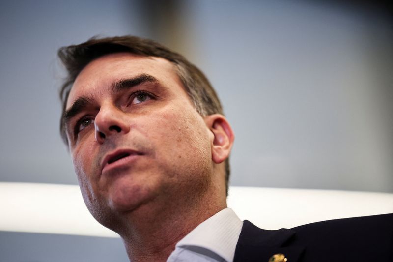 Flavio Bolsonaro speaks with members of the press after a meeting, following a scandal over messages tied to his request for funding for a biopic about former Brazilian President Jair Bolsonaro, from disgraced banker Daniel Vorcaro, who was arrested in March on suspicion of leading a multibillion-dollar fraud scheme, in Brasilia, Brazil, May 19, 2026. REUTERS/Mateus Bonomi