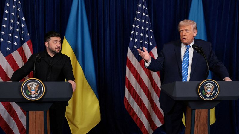 Ukrainian President Volodymyr Zelenskiy listens to U.S. President Donald Trump, after Trump said that Russian President Vladimir Putin expressed willingness to help Ukraine "succeed", during a press conference at Trump's Mar-a-Lago club, in Palm Beach, Florida, U.S., December 28, 2025. REUTERS/Jonathan Ernst/File Photo