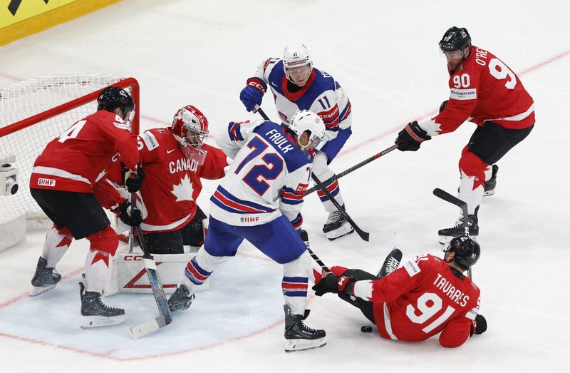 Ice Hockey - IIHF World Championships - Quarter Final - Canada v United States - BCF Arena, Fribourg, Switzerland - May 28, 2026 Justin Faulk and Oliver Moore of the U.S. in action with Canada's Morgan Rielly, John Tavares and Ryan O'Reilly REUTERS/David W Cerny