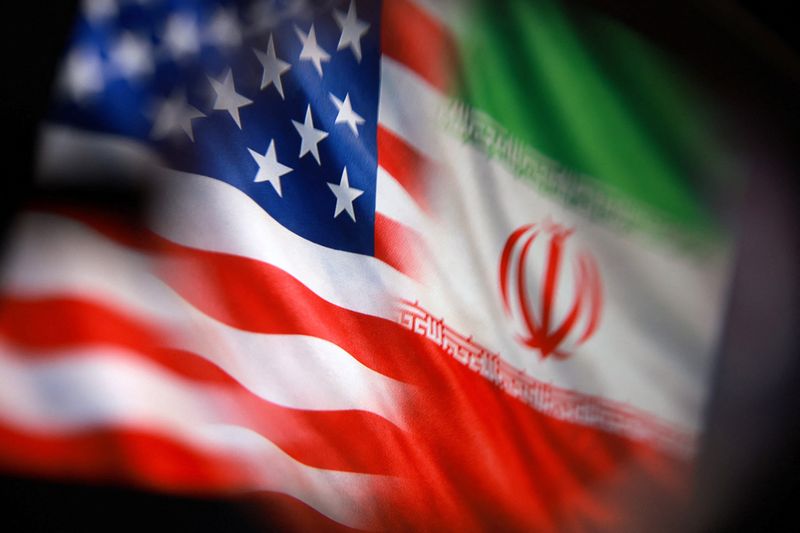U.S. and Iranian flags are seen in this illustration taken March 23, 2026. REUTERS/Dado Ruvic/Illustration