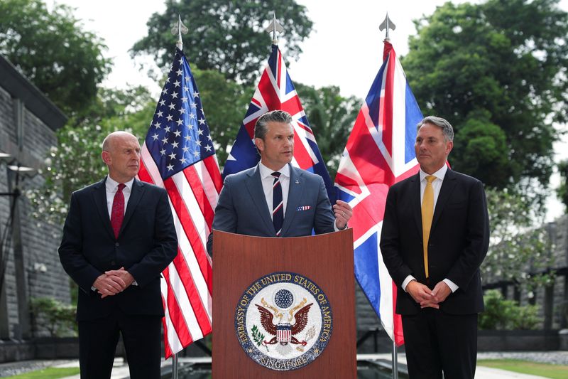 Australian Defence Minister Richard Marles and British Defence Secretary John Healey look on as U.S. Secretary of Defense Pete Hegseth speaks during an AUKUS Defence ministers' press huddle at the U.S. Embassy in Singapore, May 30, 2026. REUTERS/Edgar Su