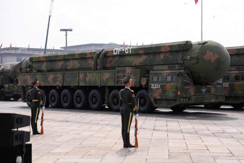FILE PHOTO: FILE PHOTO: Members of the People's Liberation Army stand as the strategic strike group displays DF-61 nuclear missiles during a military parade  in Beijing, China, September 3, 2025. REUTERS/Tingshu Wang/File Photo/File Photo