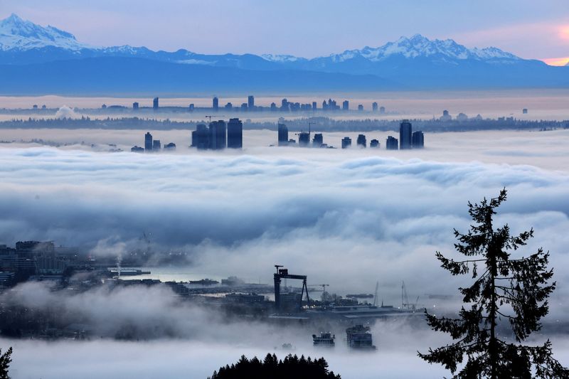 Building tops in Burnaby and Surrey rise above a thick layer of fog at dawn as a ridge of high pressure creates a coastal temperature inversion, as seen from Cypress Mountain in West Vancouver, British Columbia, Canada January 20, 2026. REUTERS/Chris Helgren