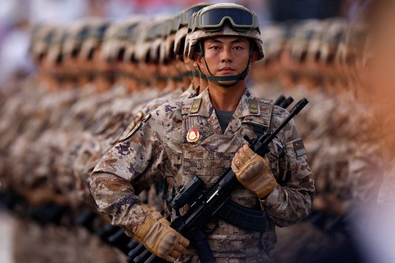 China's cyber force personnel march during the rehearsal ahead of a military parade to mark the 80th anniversary of the end of World War Two, in Beijing, China, September 3, 2025. REUTERS/Tingshu Wang