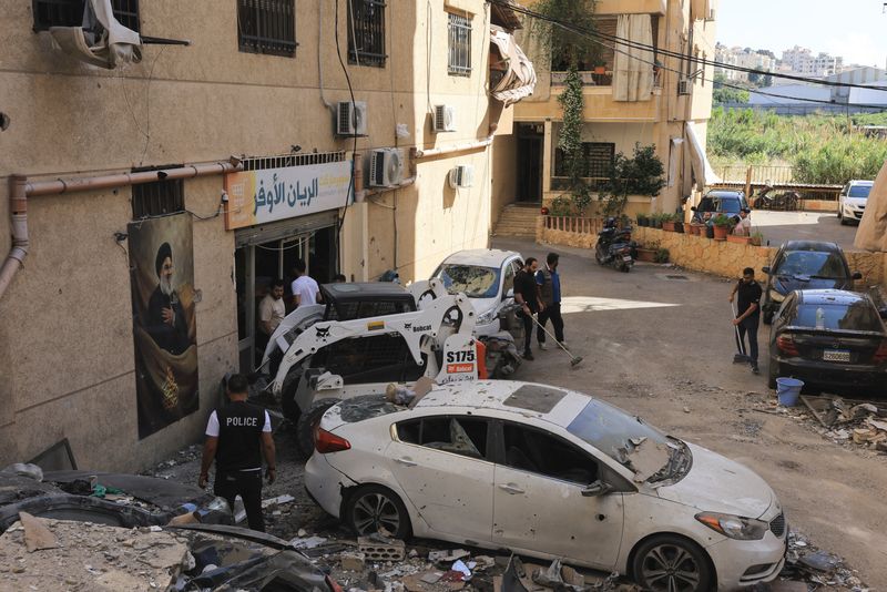 People clear the debris at the site of an Israeli strike on Beirut's southern suburbs, Lebanon, May 28, 2026. REUTERS/Raghed Waked
