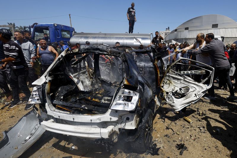 Palestinians gather at the site of an Israeli strike on a vehicle, in Deir al-Balah, in the central Gaza Strip June 2, 2026. REUTERS/Mahmoud Issa
