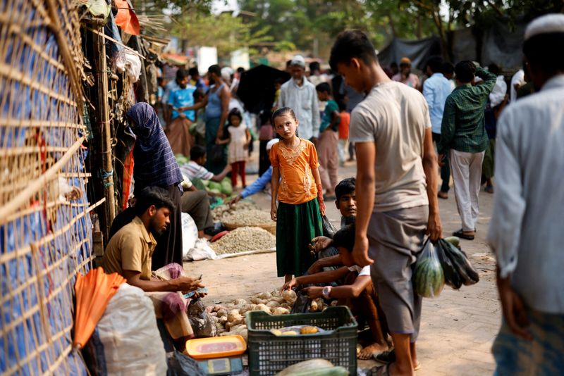 FILE PHOTO: A Rohingya refugee looks on at a roadside market inside a refugee camp in Cox’s Bazar, Bangladesh, April 17, 2026. REUTERS/Mohammad Ponir Hossain/File Photo