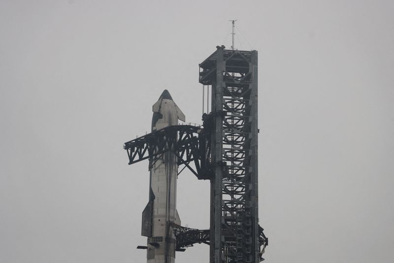 FILE PHOTO: SpaceX's next-generation Starship spacecraft stands above its powerful Super Heavy rocket after a delay of its eighth test at the company's Boca Chica launch pad in Brownsville, Texas, U.S., March 4, 2025. REUTERS/Joe Skipper/File Photo
