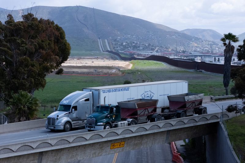 Transport trucks are shown from a drone view after clearing U.S. Customs and entering the United States from Tijuana along the U.S. Mexico border at Otay Mesa port in San Diego, California, U.S. April 2, 2025.  REUTERS/Mike Blake