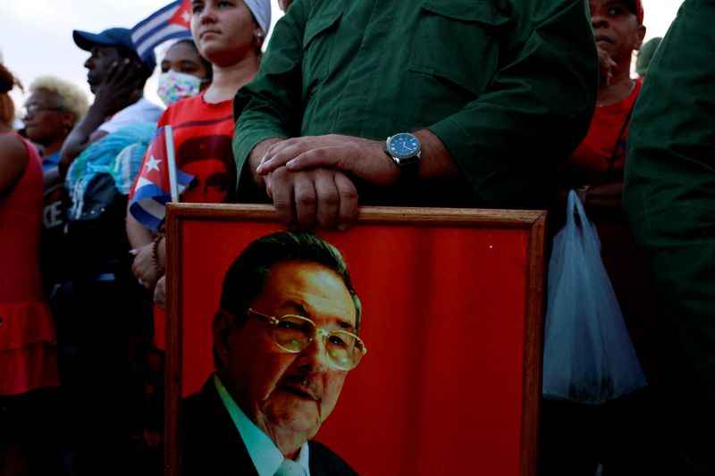 FILE PHOTO: A person holds a picture of former Cuban president Raul Castro, as people gather ahead of a pro-government rally called by Cuban authorities to protest U.S. policies toward the island, including the indictment of Castro, in Havana, Cuba, May 22, 2026. REUTERS/Norlys Perez/File Photo