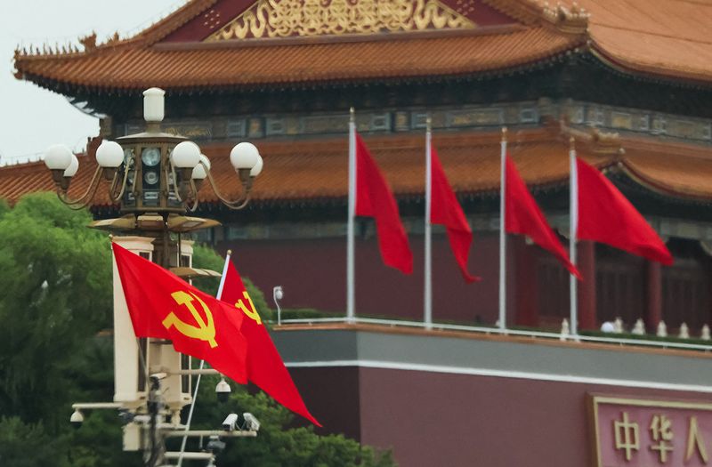 Flags of the Chinese Communist Party and the Lao People's Revolutionary Party fly next to the Tiananmen Gate in Beijing, China, June 4, 2026. REUTERS/Maxim Shemetov