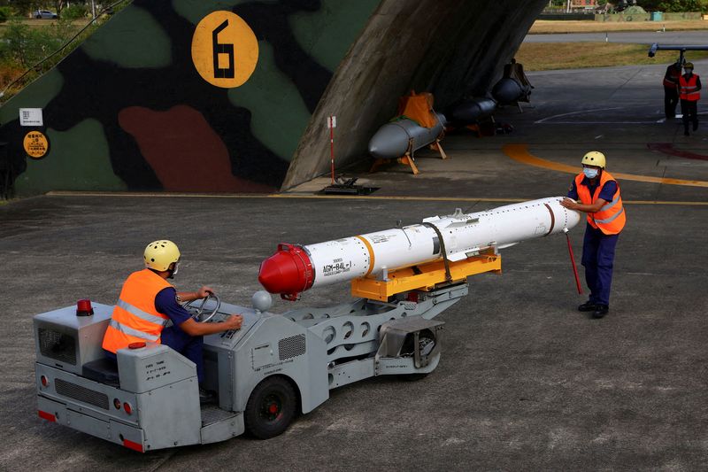 FILE PHOTO: Air force soldiers load U.S.-made Harpoon AGM-84 anti-ship missile at a combat readiness mission during a press-invited event at the airbase in Hualien, Taiwan, August 17, 2022. REUTERS/Ann Wang/File Photo