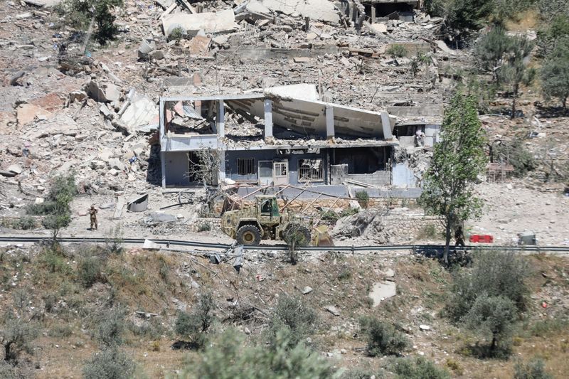 Machinery operates, as the Lebanese army opens a road, past buildings destroyed during the Israeli military campaign, in Dibbin, southern Lebanon June 4, 2026. REUTERS/Stringer