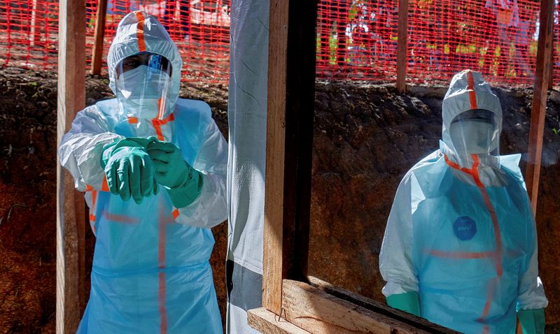 FILE PHOTO: Health workers get dressed in personal protective equipment (PPE) at the Evangelical Medical Center, one of the facilities at the forefront of the response to the Ebola outbreak, as agencies intensify efforts to contain a new Ebola outbreak caused by the Bundibugyo virus strain, in Bunia, Ituri province, Democratic Republic of Congo, May 31, 2026. REUTERS/Gradel Muyisa Mumbere/File Photo