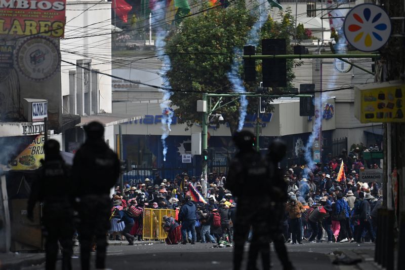 Law enforcement officers use tear gas on demonstrators during a march calling for the resignation of Bolivia's President Rodrigo Paz, as the country's economic and fuel crisis worsens due to a shortage of U.S. dollars and falling domestic energy production, in La Paz, Bolivia May 18, 2026. REUTERS/Claudia Morales