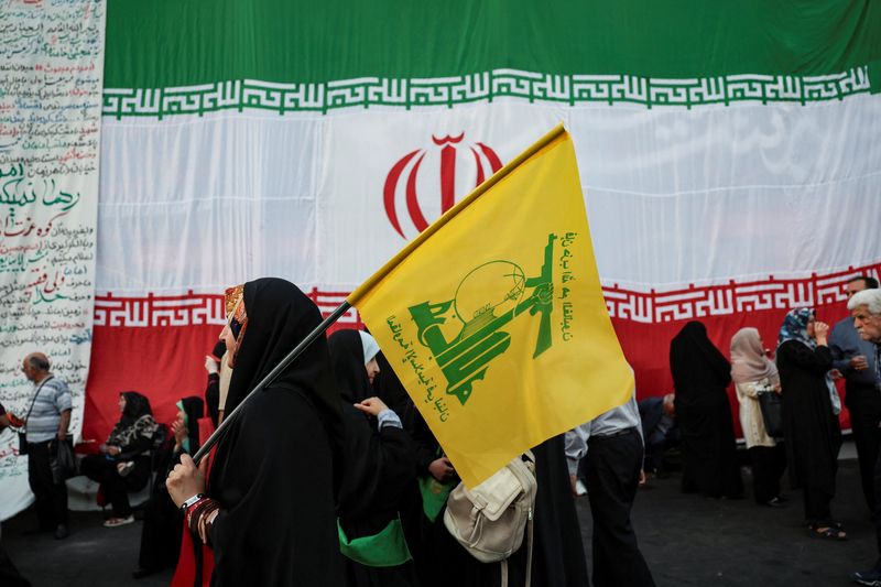 A woman holds a Hezbollah flag during a rally in support of Iran's Supreme Leader, Mojtaba Khamenei, in Tehran, Iran, June 4, 2026. Majid Asgaripour/WANA (West Asia News Agency) via REUTERS