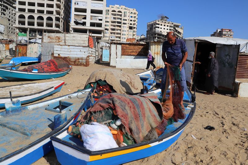 A Palestinian fisherman checks his net on the beach in Gaza City, June 3, 2026. REUTERS/Ebrahim Hajjaj