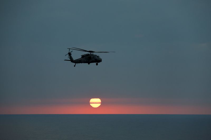 FILE PHOTO: An MH-60R Seahawk of The Swamp Foxes HSM-74 approaches the flight-deck of the USS Dwight D. Eisenhower (CVN 69) aircraft carrier during evening flight-operation in Southern Red Sea, Middle East, February 12, 2024. REUTERS/Hamad I Mohammed/File Photo