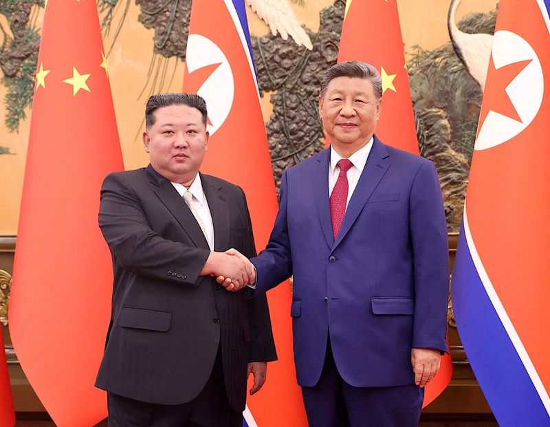 FILE PHOTO: Chinese President Xi Jinping and Democratic People's Republic of Korea (DPRK) leader Kim Jong Un shake hands at the Great Hall of the People in Beijing, China September 4, 2025. China Daily via REUTERS/File Photo