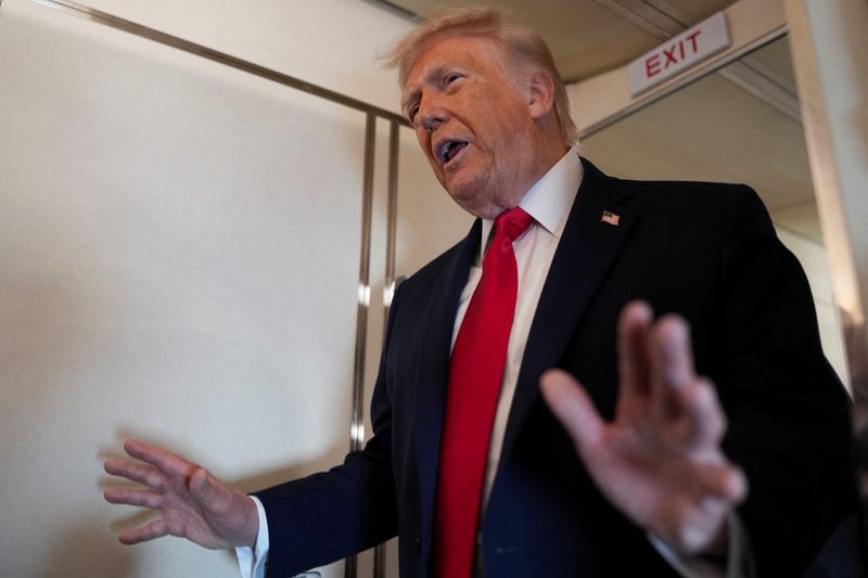 FILE PHOTO: U.S. President Donald Trump speaks to members of the media on board Air Force One while flying from Joint Base Andrews to Chippewa Valley Regional Airport in Eau Claire, Wisconsin, U.S., June 5, 2026. REUTERS/Nathan Howard/File Photo