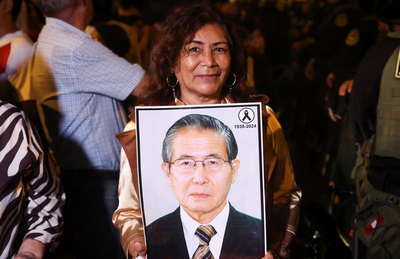A supporter of conservative presidential candidate Keiko Fujimori holds a poster with an image of Former President of Peru, Alberto Fujimori, following early results of the runoff against left-wing candidate Roberto Sanchez, in Lima, Peru June 7, 2026. REUTERS/Alessandro Cinque