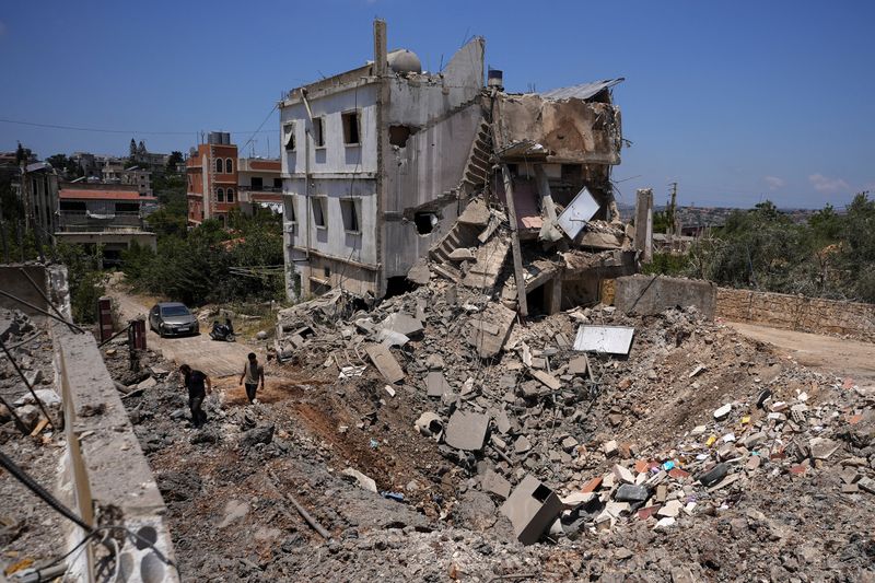People inspect the site of a previous Israeli strike in Kfar Sir in the Nabatieh district, Lebanon June 16, 2026, following a deal between the United States and Iran. REUTERS/Stringer
