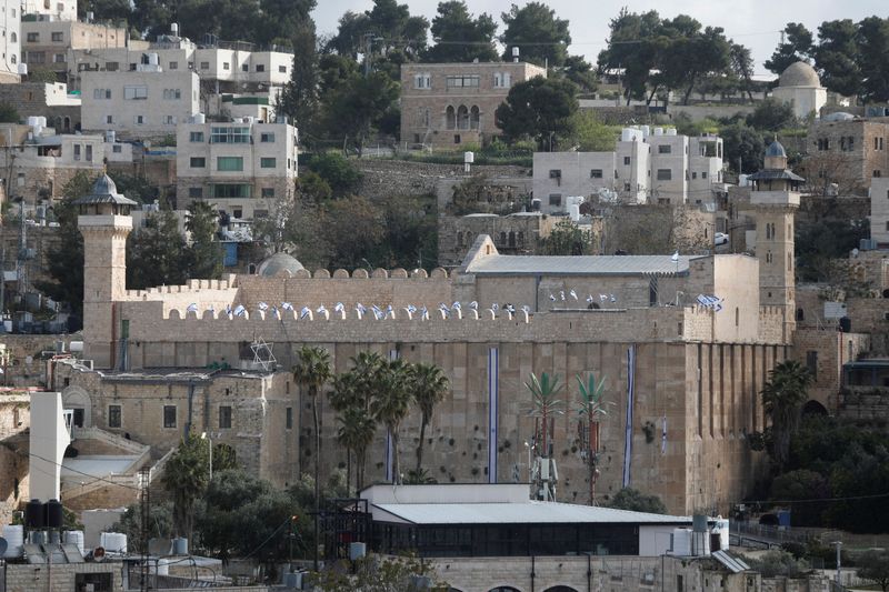 FILE PHOTO: Israeli flags flutter on the Ibrahimi mosque, also known as the Cave of the Patriarchs, in Hebron, in the Israeli-occupied West Bank April 21, 2026. REUTERS/Yosri Aljamal/File Photo