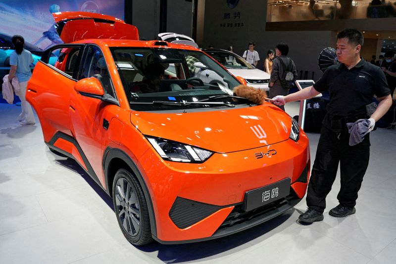 FILE PHOTO: A staff member dusts a BYD Seagull electric vehicle (EV) displayed at the Beijing International Automotive Exhibition, or Auto China, in Beijing, China April 26, 2026. REUTERS/Xiaoyu Yin/File Photo