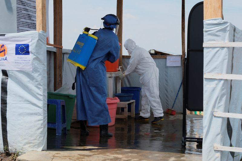 Medical workers dressed in personal protective equipment (PPE) disinfect and wash their hands at an Ebola treatment centre during a ceremony to present recovery certificates to patients at the Rwambara General Reference Hospital in Bunia, eastern Democratic Republic of Congo, June 16, 2026. REUTERS/Gradel Muyisa Mumbere