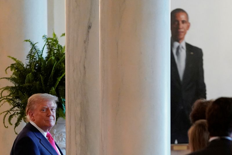 FILE PHOTO: U.S. President Donald Trump looks on as the portrait of former U.S. President Barack Obama can be seen in the background at the White House in Washington, DC., U.S., June 26, 2025. REUTERS/Nathan Howard/ File Photo