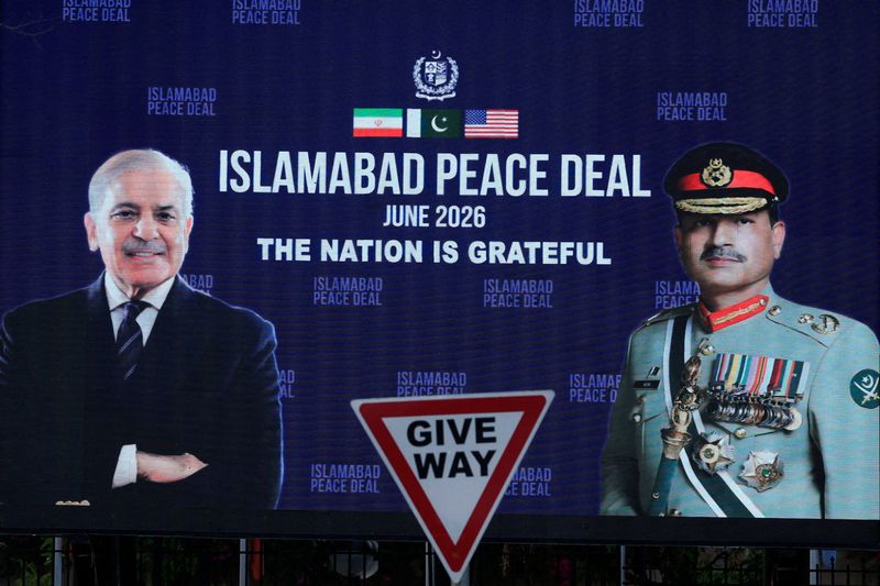 FILE PHOTO: A roadside billboard displaying portraits of Pakistan's Chief of Army Staff Field Marshal Asim Munir and Prime Minister Shehbaz Sharif, following a deal between the U.S. and Iran, in Islamabad, Pakistan, June 16, 2026. REUTERS/Akhtar Soomro/File Photo