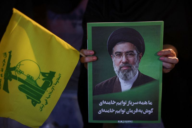 A woman holds an image of Iran's Supreme Leader, Mojtaba Khamenei, and a Hezbollah flag during a rally in Tehran, Iran, June 1, 2026. Majid Asgaripour/WANA (West Asia News Agency) via REUTERS