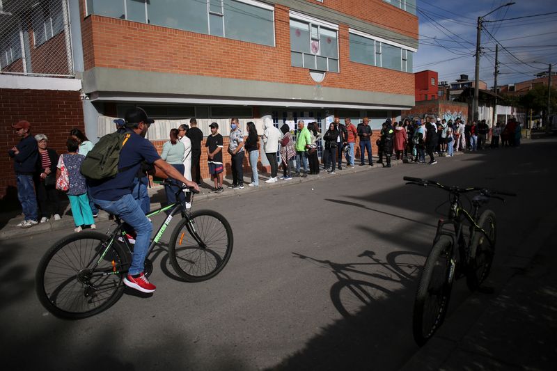 People stand in line to vote in a runoff between right-wing presidential candidate Abelardo De La Espriella and leftist candidate Ivan Cepeda, in Bogota, Colombia, June 21, 2026. REUTERS/Juan David Duque