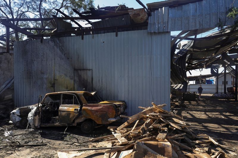 A woman walks at a compound of an agricultural enterprise hit by a Russian missile strike on Sunday evening, amid Russia's attack on Ukraine, in Odesa region, Ukraine June 22, 2026. REUTERS/Nina Liashonok