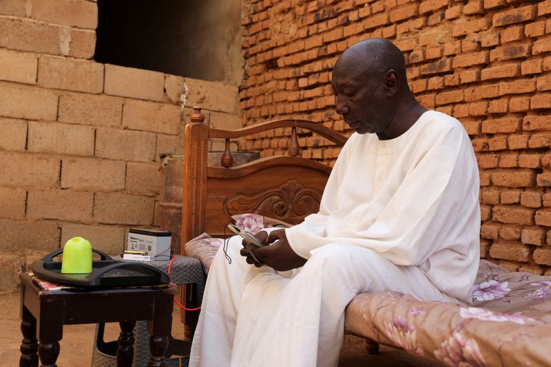 Retired Police Major General Kahil Mohamed Al-Amin, whose son was slaughtered by the Rapid Support Forces (RSF), sits on a bed during an interview, in the Salha area, south of Omdurman, Sudan, June 7, 2026. REUTERS/Stringer