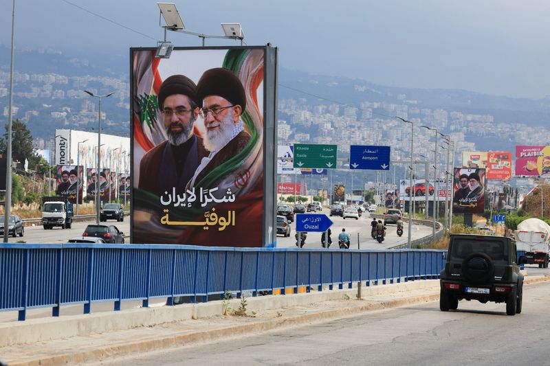 Cars and motorbikes drive past billboards showing Iran’s new Supreme Leader Ayatollah Mojtaba Khamenei and his late father Ali Khamenei, with the slogan “Thank you to loyal Iran,” erected along the highway leading to Rafic Hariri International Airport in Beirut, Lebanon June 22, 2026.REUTERS/Mohamed Azakir