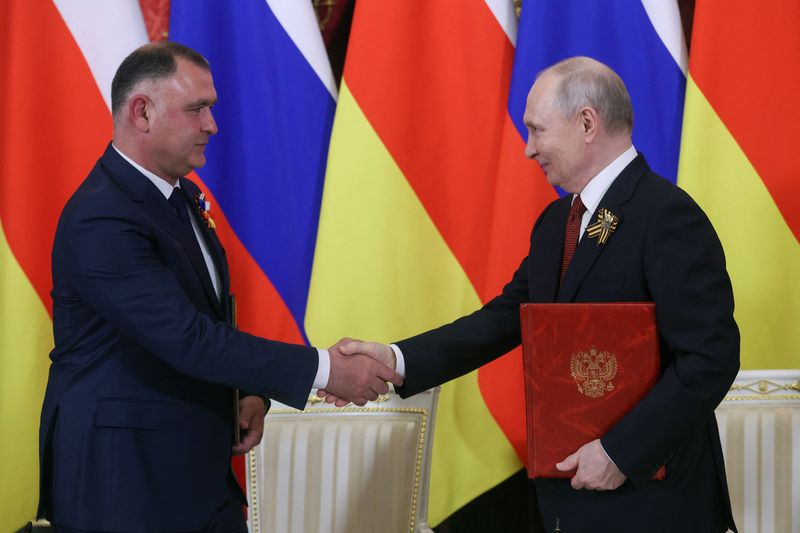 Russian President Vladimir Putin (R) and Alan Gagloyev, President of the breakaway Georgian region of South Ossetia, attend a signing ceremony following a meeting at the Kremlin in Moscow, Russia, May 9, 2026. MAXIM SHIPENKOV/Pool via REUTERS