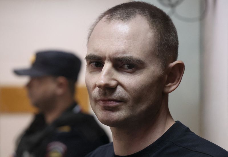 Russian opposition politician and deputy leader of the liberal Yabloko party, Maxim Kruglov, who is charged with deliberately spreading false information about the Russian army during the conflict against Ukraine, stands inside a defendants’ enclosure before a court hearing in Moscow, Russia, June 24, 2026. REUTERS/Ramil Sitdikov