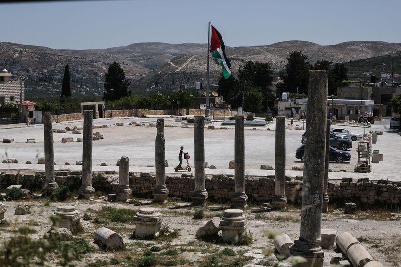 A Palestinian boy rides a scooter through archaeological remains in the ancient village of Sebastia, near Nablus in the Israeli-occupied West Bank, June 4, 2026. REUTERS/Ammar Awad