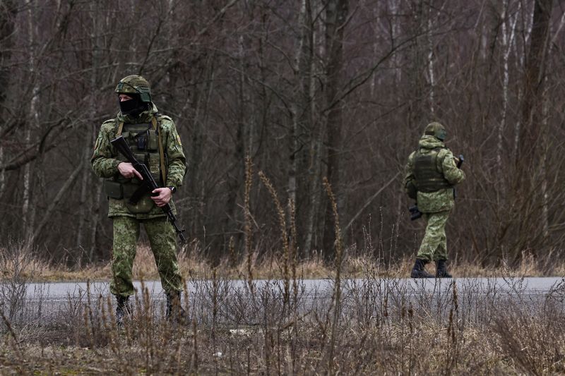 Belarusian servicemen patrol along a road near Novaya Guta crossing station on a border with Ukraine, Gomel region, Belarus January 28, 2025.  REUTERS/Evgenia Novozhenina