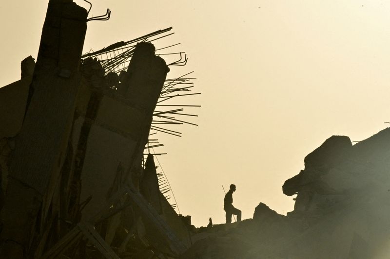 A person amidst the remains of a damaged building, in the aftermath of earthquakes in La Guaira, Venezuela, June 25, 2026. REUTERS/Maxwell Briceno