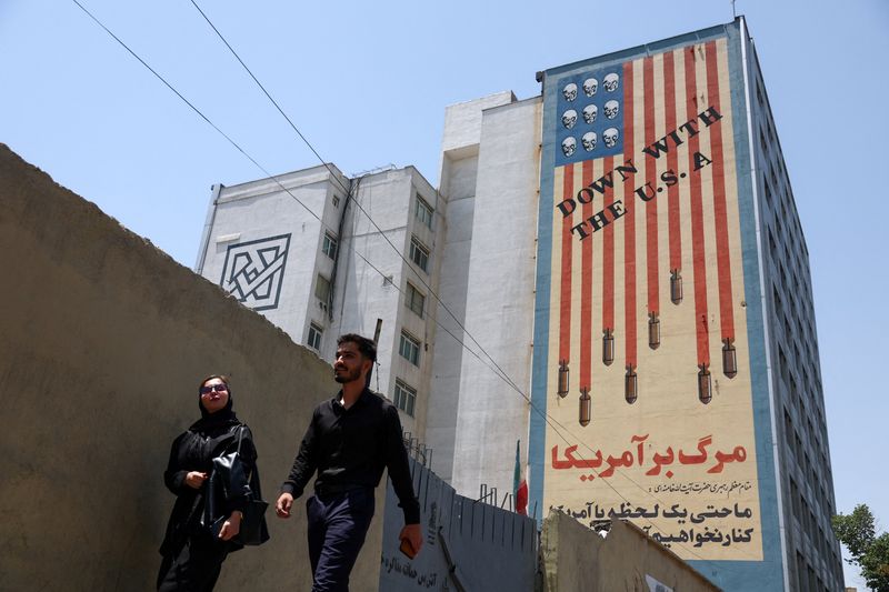 People walk near an anti-U.S. mural in Tehran, Iran, June 28, 2026. Majid Asgaripour/WANA (West Asia News Agency) via REUTERS