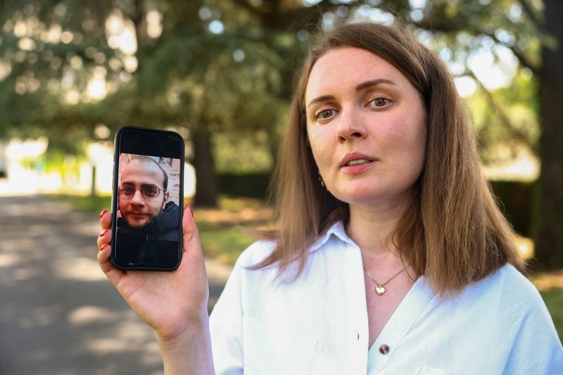 Belarussian journalist Katsyaryna Andreyeva shows a picture of her husband Ihar Ilyash on her mobile device after an interview with Reuters at the United Nations in Geneva, Switzerland, June 29, 2026. REUTERS/Denis Balibouse