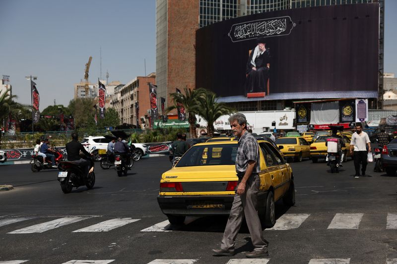 People move past a billboard with an image of Iran's late Supreme Leader Ayatollah Ali Khamenei in Tehran, Iran, June 30, 2026. Majid Asgaripour/WANA (West Asia News Agency) via REUTERS