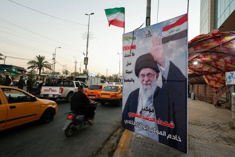 Commuters drive past a poster of Iran's late Supreme Leader Ayatollah Ali Khamenei ahead of funeral processions, in Karbala, Iraq, July 7, 2026. REUTERS/Khalid Al-Mousily