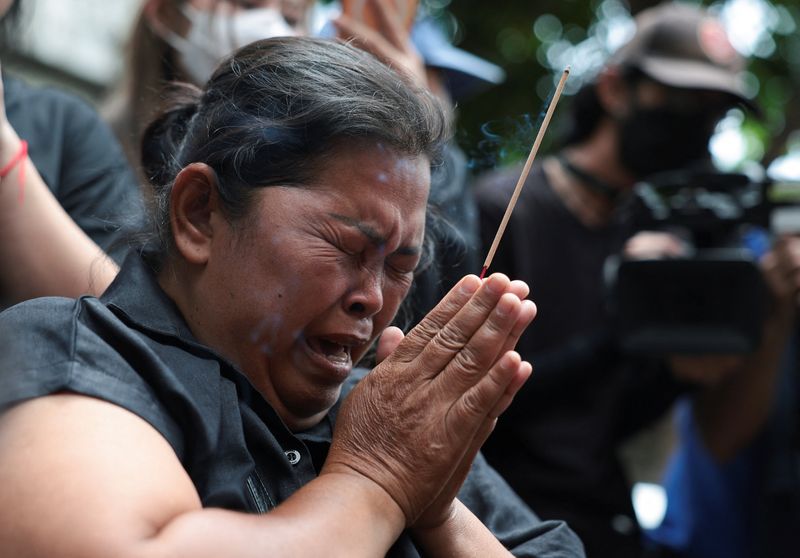 Mother of the victim, Kanokthip Srisuk, visits Rong Beer Na Lat Phrao bar, the site of a deadly fire, to pay tribute to Srisuk and other victims who lost their lives in the bar fire, the day after the incident, in Bangkok, Thailand, July 14, 2026. REUTERS/Chalinee Thirasupa